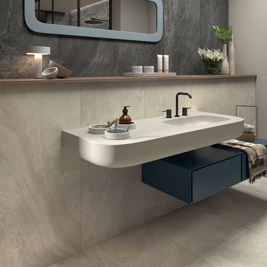 Bagno con rivestimenti beige e lavabo sospeso dal design morbido
